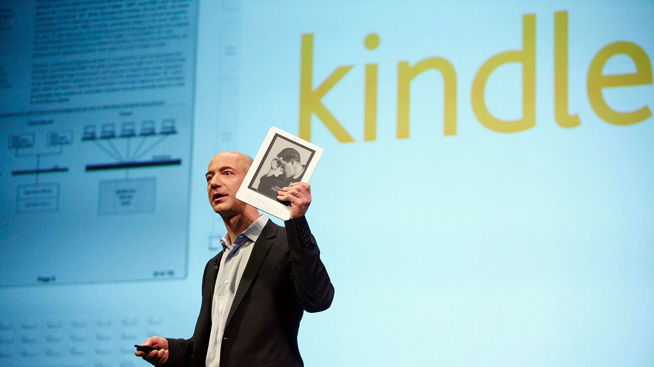 Amazon.com founder and CEO Jeff Bezos holds the new Kindle DX electronic reader