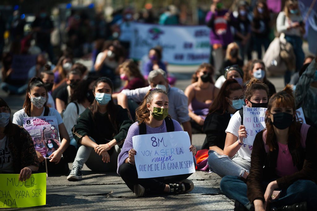 Mujeres Málaga Demonstrators are seen sitting on the street and holding