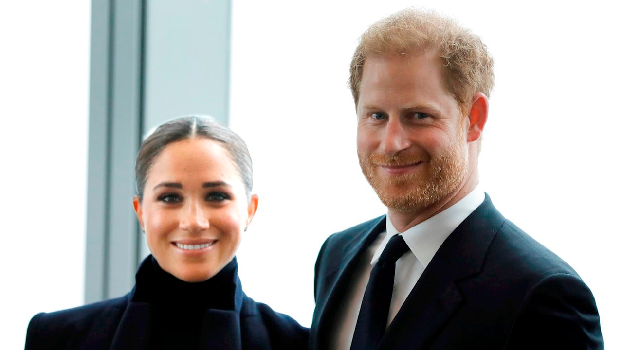 Britain's Prince Harry, Duke of Sussex (R) and his wife Meghan, Duchess of Sussex