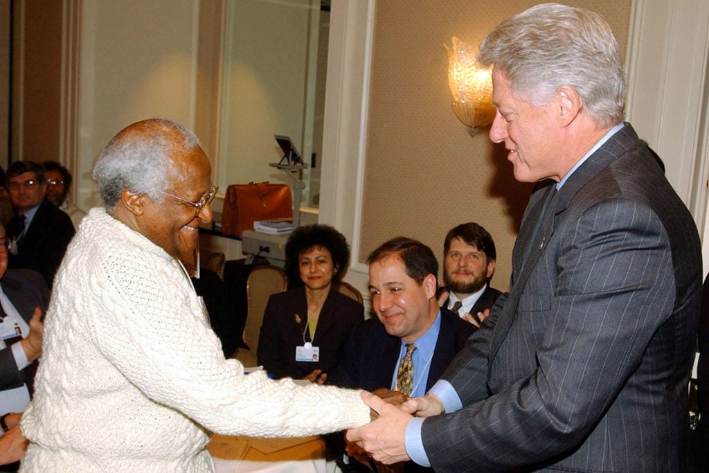 Desmond Tutu (L), Archbishop Emeritus of South Africa, shakes hands with former U.S. President Bill ..