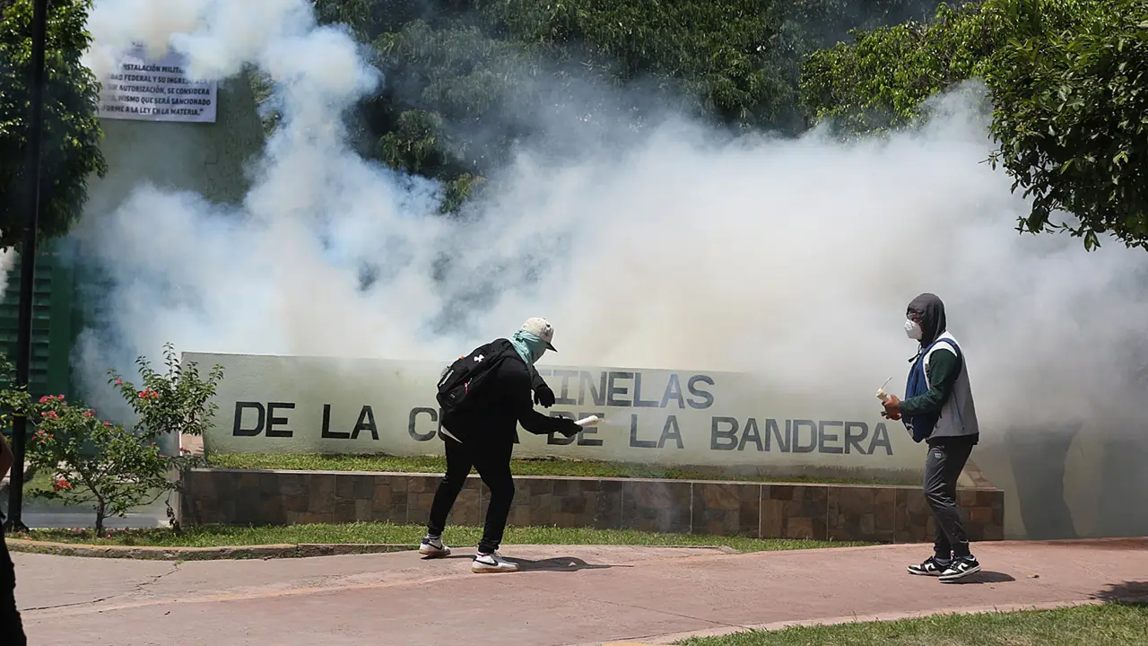 Activistas de Ayotzinapa lanzan petardos y causan incendios frente a cuartel del Ejército